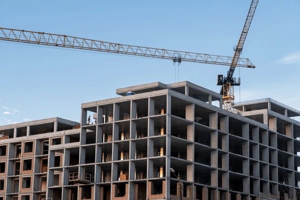 Half-built construction site with worried businessman